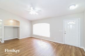 North Port house for rent - a living room with hardwood flooring and a white door