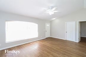 North Port house for rent - a living room with wood floors and a ceiling fan