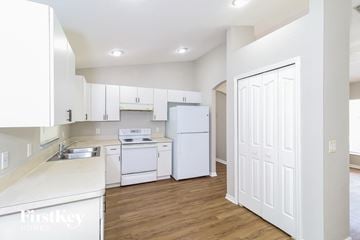 North Port house for rent - a white kitchen with white appliances and white cabinets