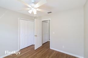 North Port house for rent - a bedroom with two closets and a ceiling fan