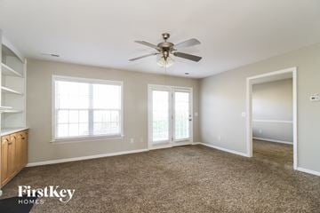 Winston-Salem house for rent - a living room with carpet and a ceiling fan