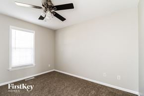 Winston-Salem house for rent - a bedroom with a ceiling fan and carpet