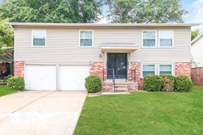 Florissant house for rent - A house with a grey facade and a black door.