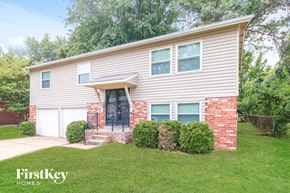 Florissant house for rent - A house with a garage and a brick wall.
