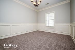Snellville house for rent - A room with a chandelier and a window.