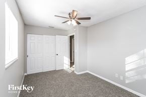 Tampa house for rent - a bedroom with a ceiling fan and a door to a closet