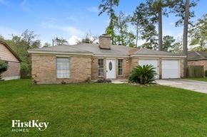 Spring house for rent - a brick house with a lawn and a white garage door