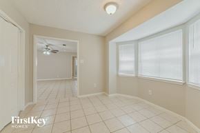 Spring house for rent - a living room with a ceiling fan and a tiled floor