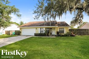 Eustis house for rent - A house with a yellow front and a brown roof is for sale.
