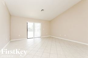 Eustis house for rent - A spacious empty room with a sliding glass door.
