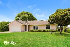 Port St. Lucie house for rent - a house with a lawn and a tree