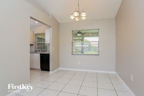 Port St. Lucie house for rent - a kitchen and living room with a white tiled floor