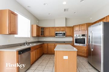 Ruskin house for rent - A kitchen with wooden cabinets and stainless steel appliances.