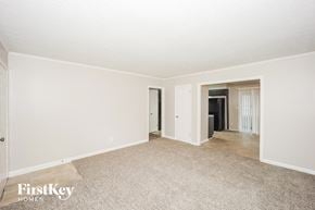 Ellenwood house for rent - A carpeted room with a door and a window.