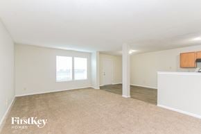 Indianapolis house for rent - A spacious room with a carpeted floor and a white ceiling.