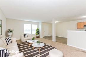 Indianapolis house for rent - A living room with a white couch, a coffee table, and a rug.