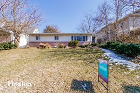 Indianapolis house for rent - a white house with a yard and a sidewalk