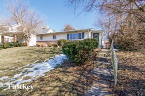 Indianapolis house for rent - a white house with stairs and a yard with snow