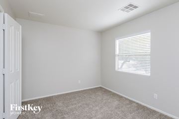 San Tan Valley house for rent - a bedroom with white walls and carpet and a window