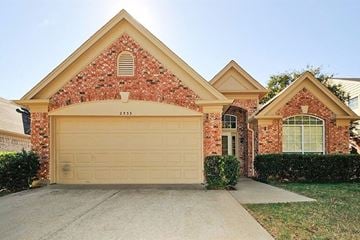 Fort Worth house for rent - the front of a brick house with a white garage door