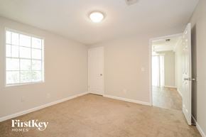 Adamsville house for rent - A spacious room with a carpeted floor and a window on the left wall.