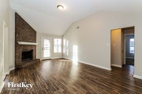 Memphis house for rent - the living room with wood flooring and a fireplace