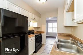 Memphis house for rent - a kitchen with black appliances and white cabinets