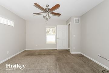 Port St. Lucie house for rent - a living room with carpet and a ceiling fan