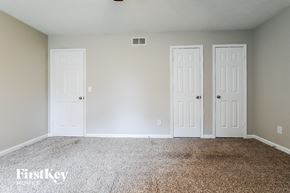 Duluth house for rent - an empty room with two doors and a carpeted floor