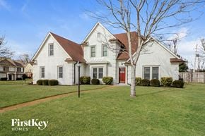 Memphis house for rent - a white house with a yard and a red door