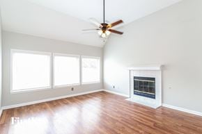 Memphis house for rent - an empty living room with a ceiling fan and a fireplace
