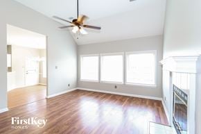 Memphis house for rent - an empty living room with wood floors and a ceiling fan