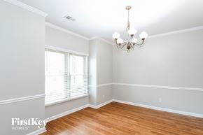 Memphis house for rent - an empty dining room with wood floors and a chandelier