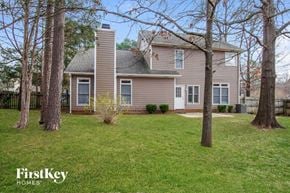 Matthews house for rent - a house with a yard and trees in front of it