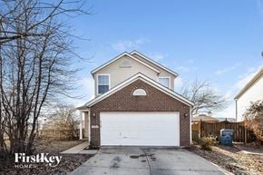 Indianapolis house for rent - a brick house with a white garage door