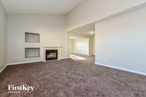 Indianapolis house for rent - a living room with a carpeted floor and a fireplace