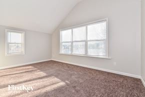 Indianapolis house for rent - a bedroom with carpet and a large window