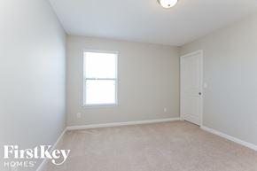 Charlotte house for rent - a bedroom with white walls and a window and a white door