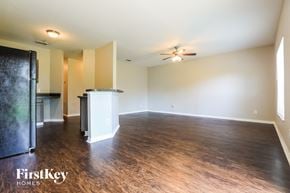 North Port house for rent - an empty living room with wood flooring and a ceiling fan
