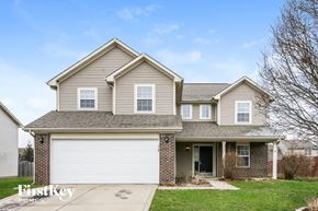 Plainfield house for rent - a tan house with a white garage door