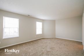 Plainfield house for rent - a bedroom with a carpeted floor and two windows