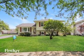 Plainfield house for rent - a house with a lawn and a blue sign in front of it