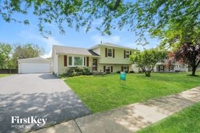 Plainfield house for rent - a yellow house with a lawn and a driveway