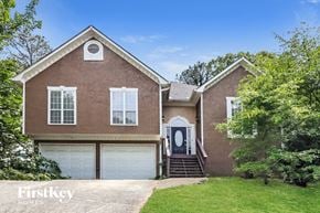Marietta house for rent - a brick house with a white garage door