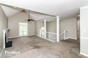 Marietta house for rent - an empty living room with a ceiling fan and a staircase