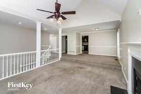 Marietta house for rent - a empty living room with a ceiling fan and stairs