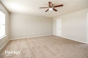Texas City house for rent - A room with a ceiling fan and carpeted floor.