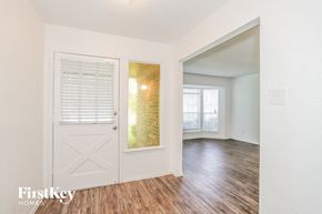 Oak Ridge North house for rent - the living room and dining room of an apartment with wood floors and a white door