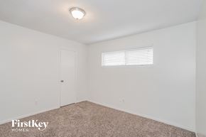 Oak Ridge North house for rent - a bedroom with white walls and carpet and a white door