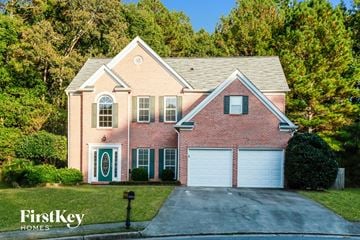 Dacula house for rent - a brick house with a white garage door